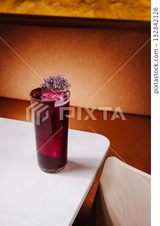 Refreshing drink served in a tall glass with flowers on the rim Refreshing drink served in a tall glass with flowers on the rim 132842126