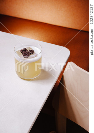Refreshing cocktail on a stylish table in a cozy setting Refreshing cocktail on a stylish table in a cozy setting 132842127