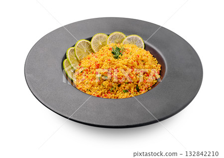 Delicious couscous dish served with fresh lime slices and herbs Delicious couscous dish served with fresh lime slices and herbs 132842210