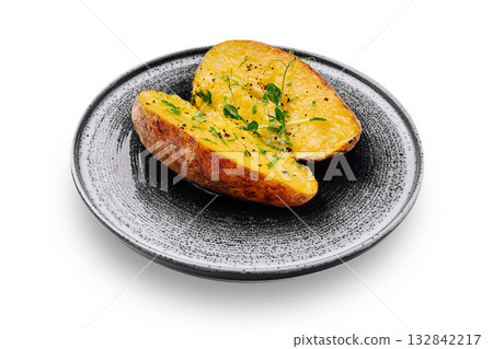 Baked potato served on a black plate with fresh herbs Baked potato served on a black plate with fresh herbs 132842217