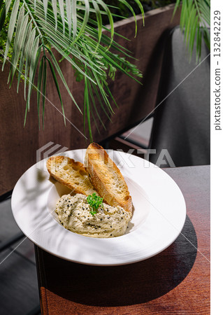 Tasty bread and creamy spread served in a cozy restaurant setting Tasty bread and creamy spread served in a cozy restaurant setting 132842229