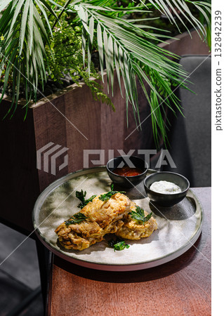 Delicious fried chicken served with sauces in a restaurant setting Delicious fried chicken served with sauces in a restaurant setting 132842239