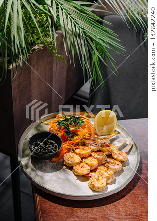 Fresh shrimp meal with vegetables and lemon in a restaurant setting Fresh shrimp meal with vegetables and lemon in a restaurant setting 132842240