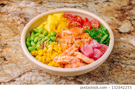 Colorful poke bowl with fresh ingredients in a round dish Colorful poke bowl with fresh ingredients in a round dish 132842255