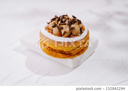 Delicious dessert with cream and chocolate shavings on a white background 132842294