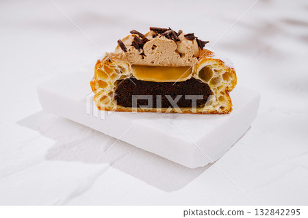 Chocolate dessert with creamy filling and crispy pastry layers on display Chocolate dessert with creamy filling and crispy pastry layers on display 132842295