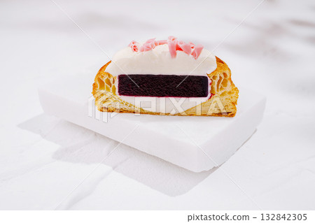 Delicious dessert featuring a flaky pastry filled with cream and berry layer Delicious dessert featuring a flaky pastry filled with cream and berry layer 132842305