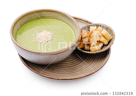 Fresh green soup served with crispy bread on a wooden plate Fresh green soup served with crispy bread on a wooden plate 132842319
