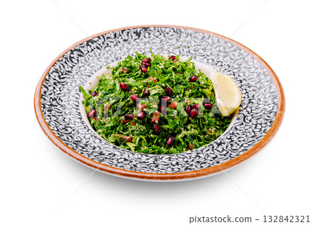 Fresh and vibrant herb salad with pomegranate and lemon garnish Fresh and vibrant herb salad with pomegranate and lemon garnish 132842321