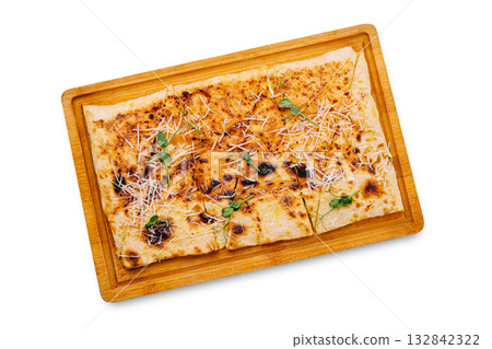 Crispy flatbread topped with cheese and herbs on a wooden serving board Crispy flatbread topped with cheese and herbs on a wooden serving board 132842322