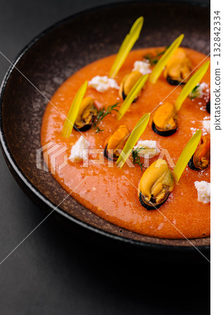 Delicious seafood dish served on a dark plate at a modern restaurant 132842334