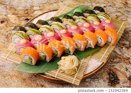 Sushi platter featuring assorted rolls presented on a decorative tray Sushi platter featuring assorted rolls presented on a decorative tray 132842364