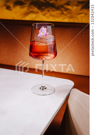 Elegant cocktail served with a flower garnish in a stylish setting Elegant cocktail served with a flower garnish in a stylish setting 132842415