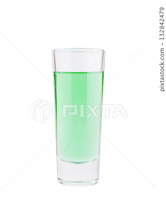 Bright green drink in a clear glass on a white background Bright green drink in a clear glass on a white background 132842479