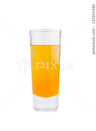 Bright orange drink in a tall glass on a clean white background 132842480
