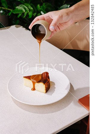 Delicious dessert experience with caramel sauce on cheesecake slice Delicious dessert experience with caramel sauce on cheesecake slice 132842485