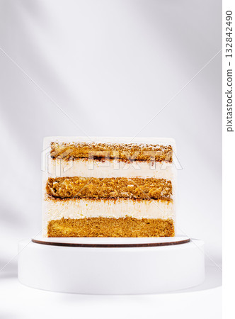 Delicious layered cake with cream frosting on a simple stand 132842490