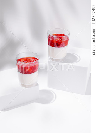 Delicious strawberry dessert served in clear glasses on a white background 132842495