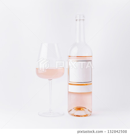 Enjoying a glass of rose wine with a bottle on a light background 132842508