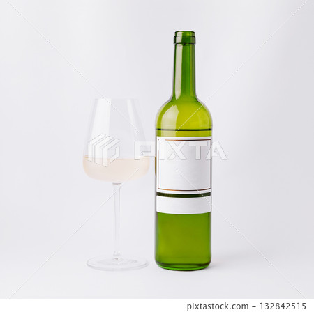 White wine bottle and glass on a simple background White wine bottle and glass on a simple background 132842515