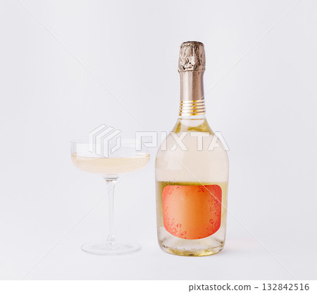 Celebrate with sparkling wine and a stylish glass in a minimal setting Celebrate with sparkling wine and a stylish glass in a minimal setting 132842516