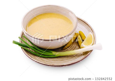 Creamy sauce served with fresh greens and lemon on a clay plate Creamy sauce served with fresh greens and lemon on a clay plate 132842552