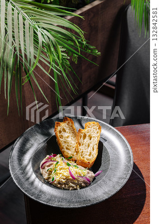 Delicious plate of local dish served with bread in a stylish setting Delicious plate of local dish served with bread in a stylish setting 132842581