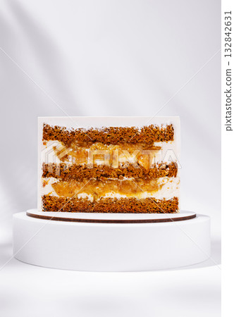 Delicious layered cake with cream and crunch on a white backdrop Delicious layered cake with cream and crunch on a white backdrop 132842631