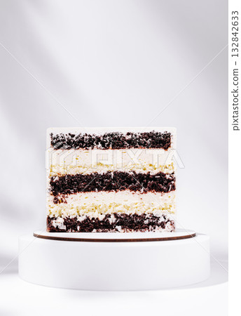 Decorative cake on a white stand with chocolate and cream layers Decorative cake on a white stand with chocolate and cream layers 132842633
