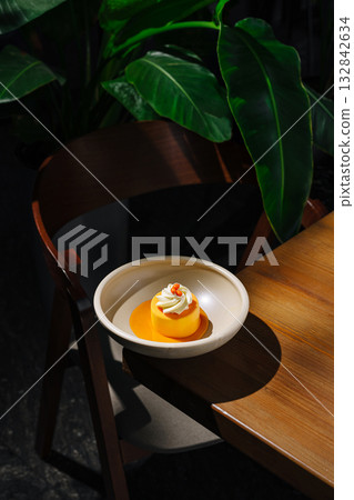 Delicious dessert on a table in a cozy cafe surrounded by greenery 132842634
