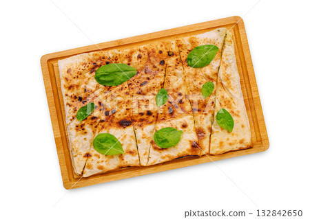 Delicious flatbread topped with fresh spinach on a wooden serving tray 132842650