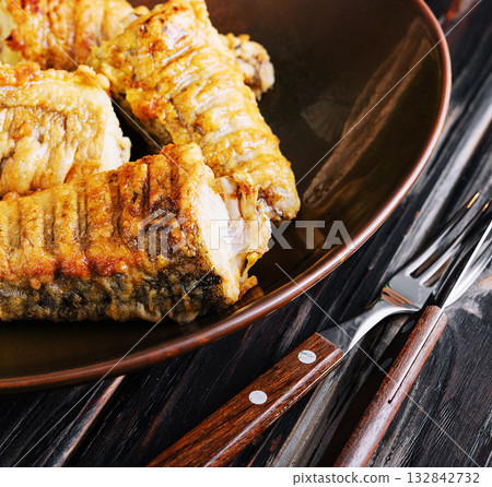 Delicious grilled fish fillets on ceramic plate 132842732