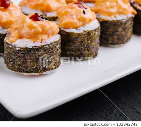 Delicious spicy tuna sushi rolls on white plate 132842742