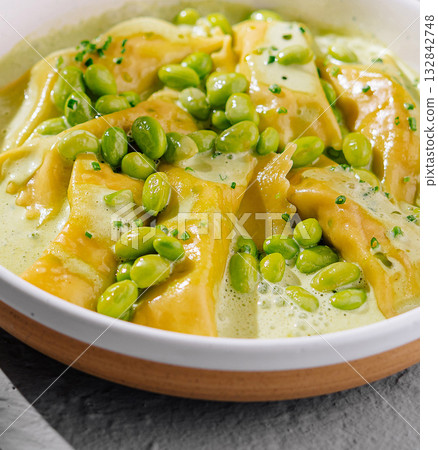 Fresh ravioli pasta with green pea sauce Fresh ravioli pasta with green pea sauce 132842748