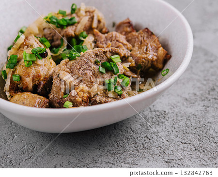 Savory braised beef dish with scallions Savory braised beef dish with scallions 132842763