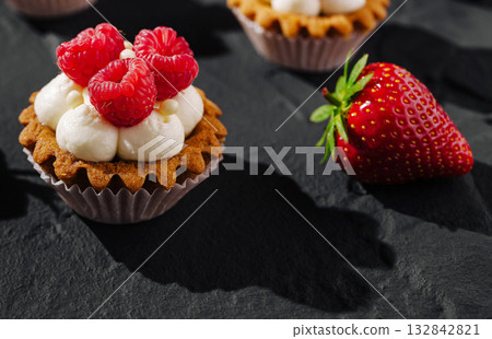 Delicious dessert with raspberries and strawberries on a textured surface 132842821