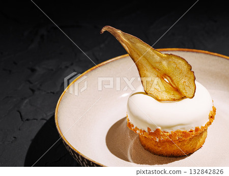 Unique dessert featuring creamy topping and dried fruit decoration Unique dessert featuring creamy topping and dried fruit decoration 132842826