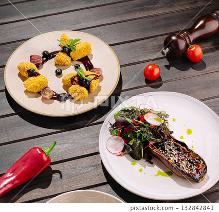 Colorful gourmet dishes presented on wooden table with fresh ingredients nearby Colorful gourmet dishes presented on wooden table with fresh ingredients nearby 132842841