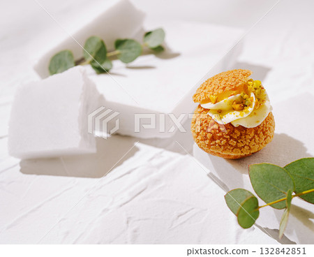 Delicious dessert featuring cream and pistachios on a minimalist background Delicious dessert featuring cream and pistachios on a minimalist background 132842851