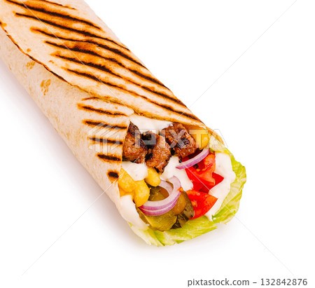 Delicious grilled burrito filled with meat and fresh vegetables Delicious grilled burrito filled with meat and fresh vegetables 132842876