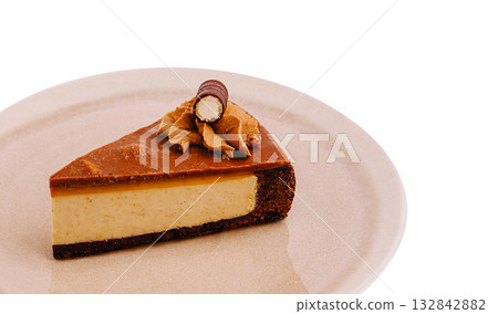 Delicious chocolate caramel cheesecake slice served on a plate Delicious chocolate caramel cheesecake slice served on a plate 132842882