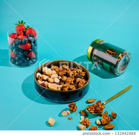 Healthy snack assortment with berries and granola on a vibrant background Healthy snack assortment with berries and granola on a vibrant background 132842888