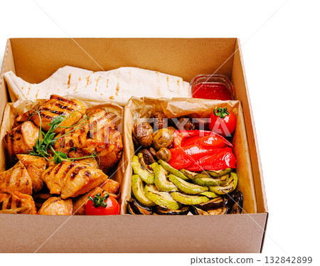 Grilled chicken and vegetable platter served in a takeaway box Grilled chicken and vegetable platter served in a takeaway box 132842899