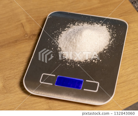 White powdered substance on electronic scale 132843060