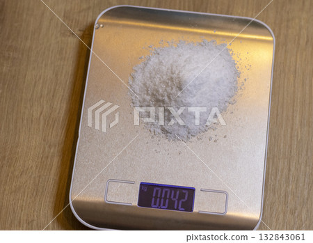 White powdered substance on electronic scale White powdered substance on electronic scale 132843061