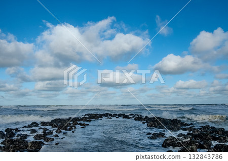 textured rock configuration creates scenic route to expansive sea horizon under scattered clouds textured rock configuration creates scenic route to expansive sea horizon under scattered clouds 132843786