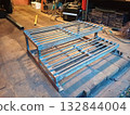A welded structure of a small ladder made of metal angles and reinforcement. 132844004