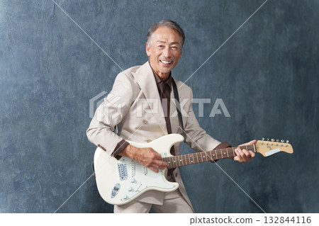 Senior man playing electric guitar Senior man playing electric guitar 132844116