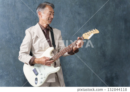 Senior man playing electric guitar Senior man playing electric guitar 132844118