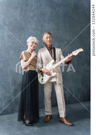 Senior men and women forming a rock band 132844144